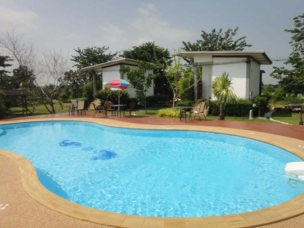 a large blue swimming pool with a gazebo at Baan Suan Thanwalai Khon Kaen in Khon Kaen