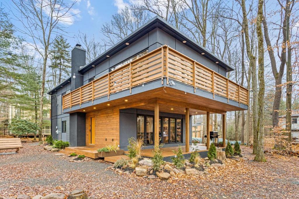 a house with a black roof and wood at Pine Breeze in Pocono Pines