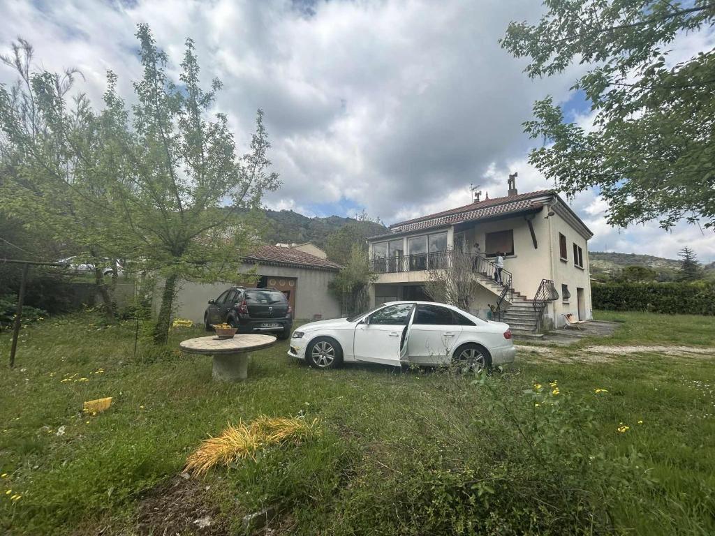 a white car parked in front of a house at Maison DARDECH in Rochemaure