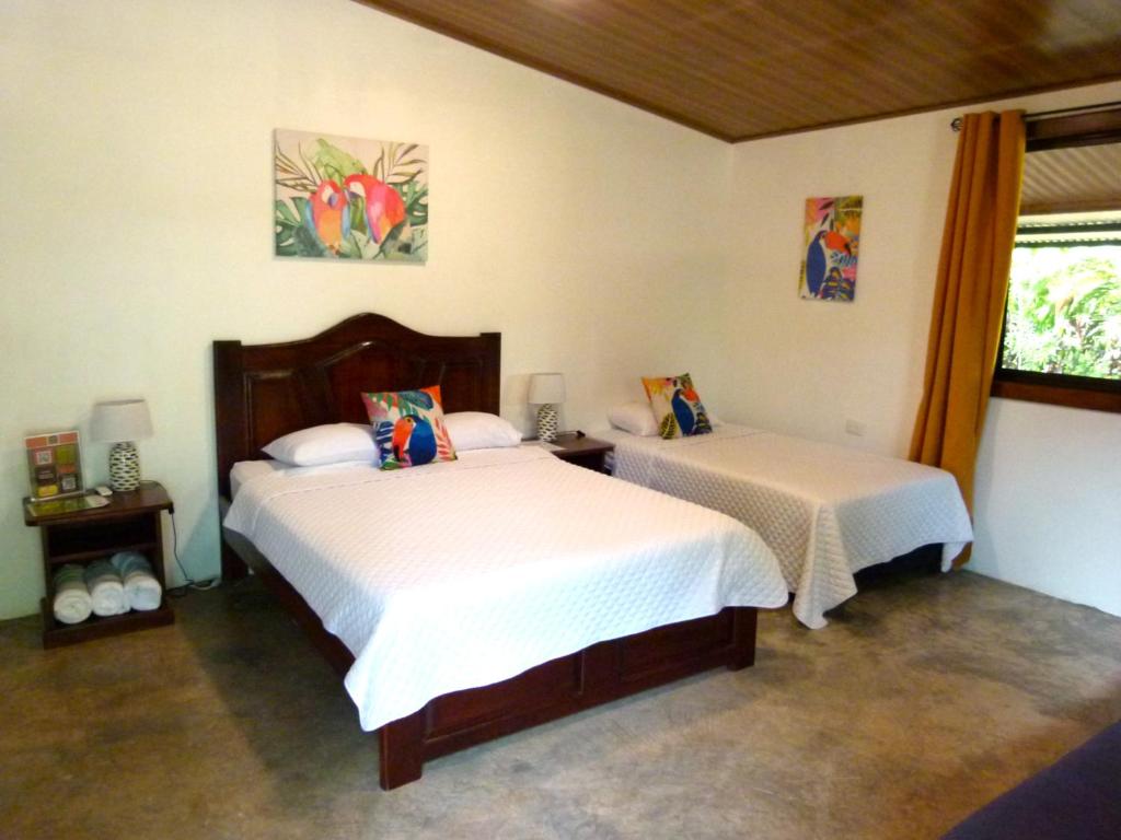 a bedroom with two beds and a window at Primer Canto B&B - Near Ferry & Early Birdwatching Trails in Lepanto