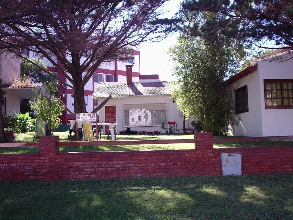 a brick fence in front of a house at Hostal Sur in Villa Gesell