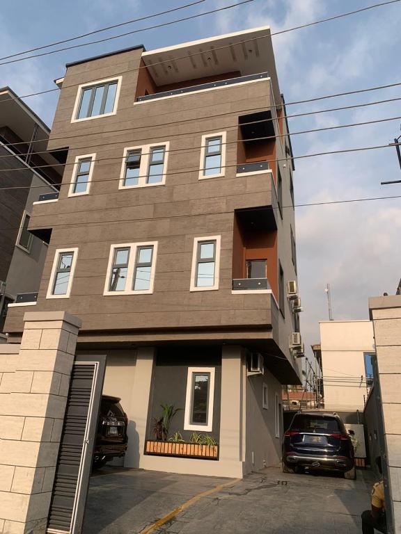 a building with two cars parked in front of it at The Maridoc in Lagos