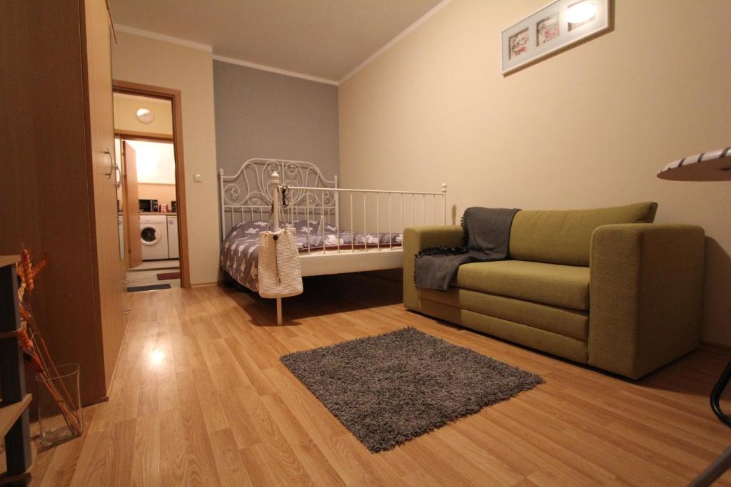 a living room with a couch and a baby crib at Apartment 132 in Sofia