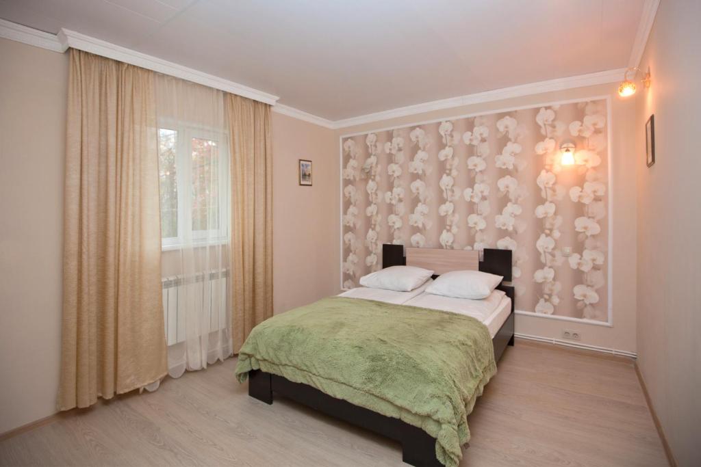 En eller flere senger på et rom på Novoselkovsky Guest House
