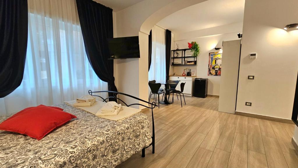 a bedroom with a bed with a red pillow on it at Talenti Suites Rome Casa Vacanze in Rome