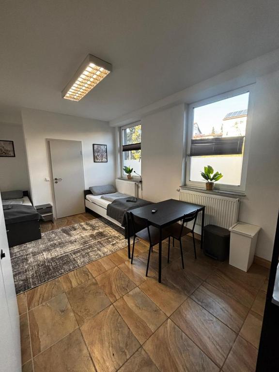 a living room with a table and a couch at Monteur Boardinghouse WorkHomes Zuffenhausen in Stuttgart