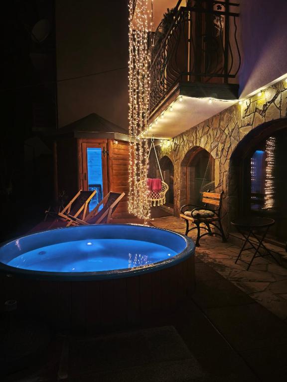 a large hot tub in a room with a fireplace at Willa Grono in Krościenko