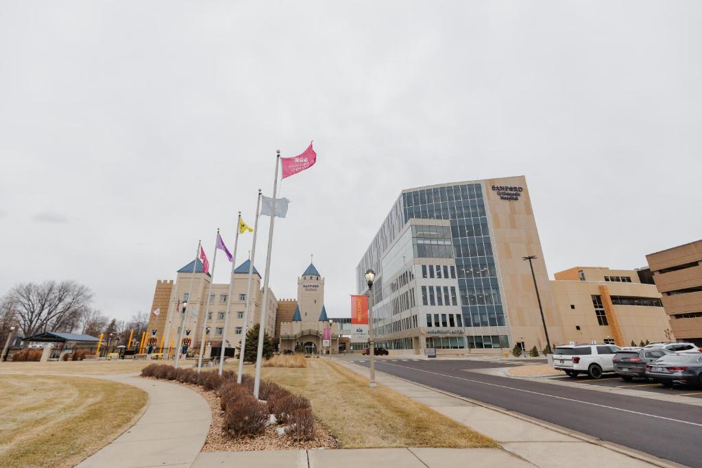 a city street with flags in front of buildings at Highpoint Hotel in Sioux Falls