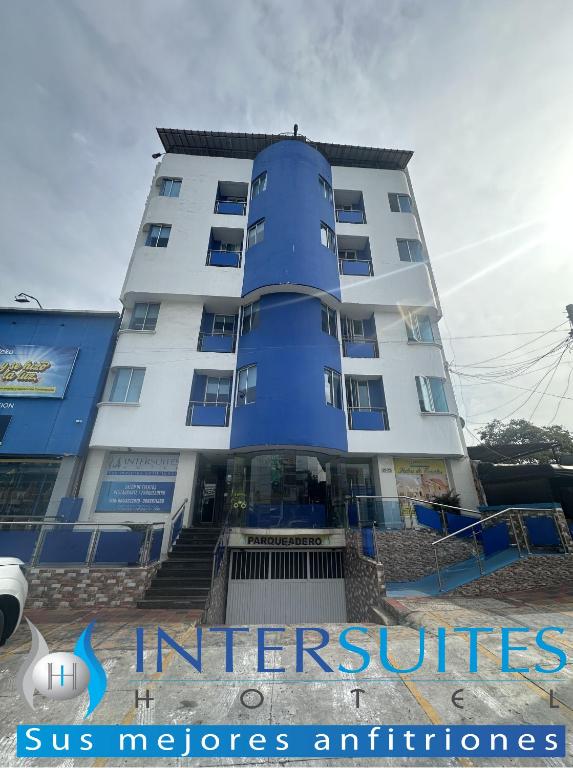 a large white building with a blue at Hotel Intersuites in Barranquilla