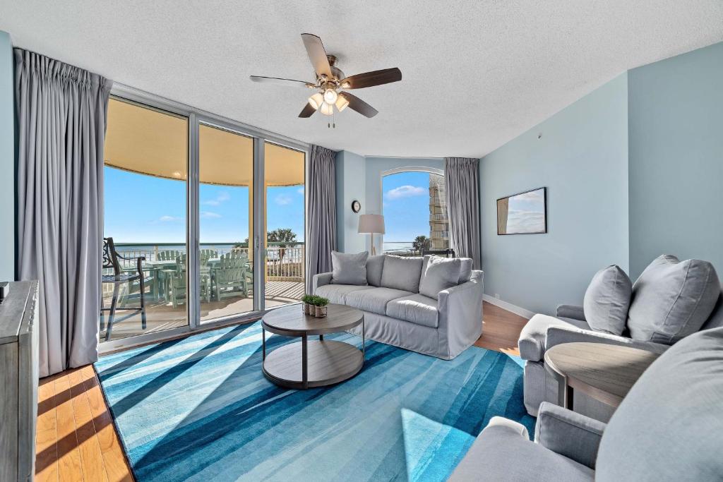 a living room with a couch and a ceiling fan at Beach Colony East Unit 1C in Pensacola