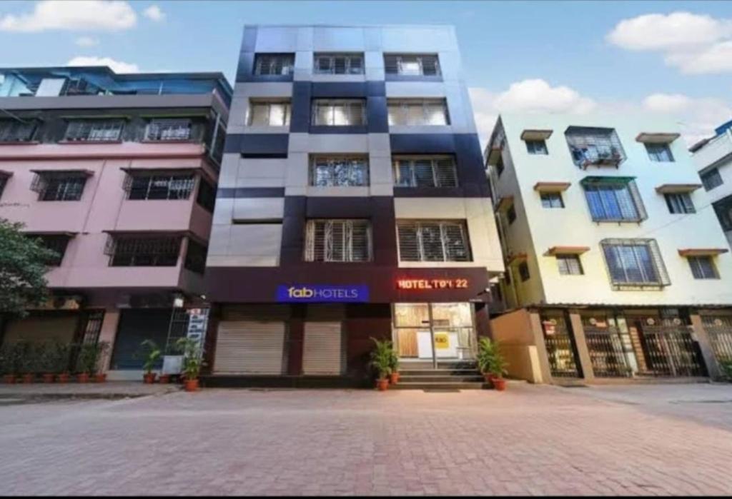 a large building in a city with a street at Top Comfort in Kolkata