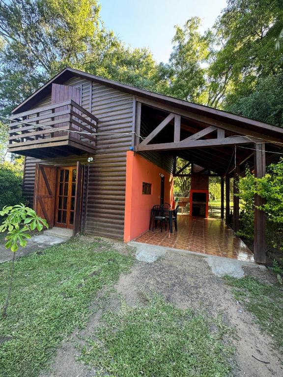 a house with a deck and a balcony at Cabaña UNO Refugio in Paso de la Patria
