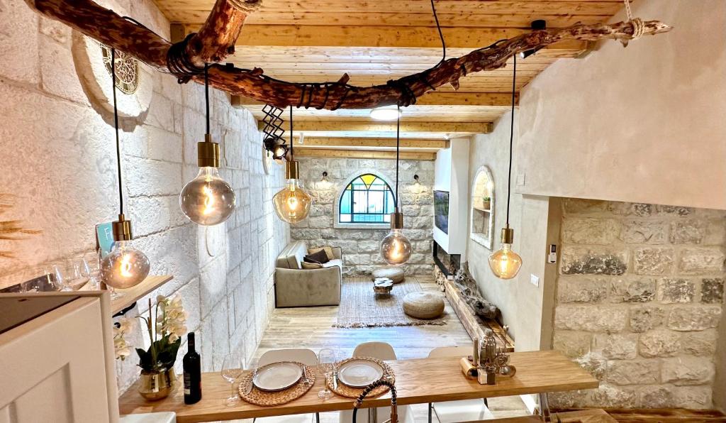 a kitchen with pendant lights and a living room at Bankers 1880 The Turkish Quarter hotel in Haifa