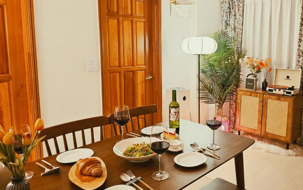 a table with a bottle of wine and a plate of food at Stay EROB in Seoul