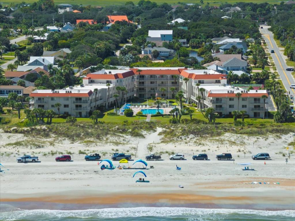 an aerial view of a beach with cars and umbrellas at Spanish Trace 235 in St. Augustine