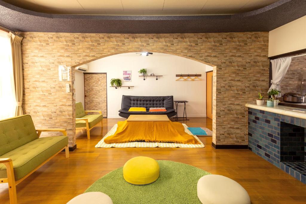 a living room with a couch and a table at inn 1st in Yakage