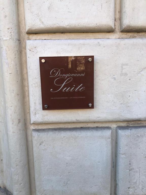 a sign on a door on a building at Dongiovanni Suite in Lecce