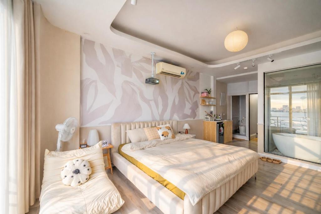 a bedroom with a bed and a bath tub in it at Aimee House Vũ Miên in Hanoi