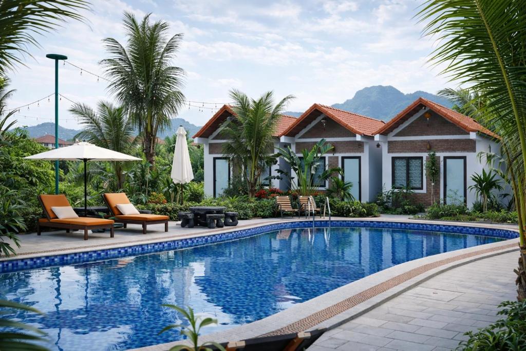 a swimming pool in front of a house at Senna Garden Homestay in Xuân Sơn