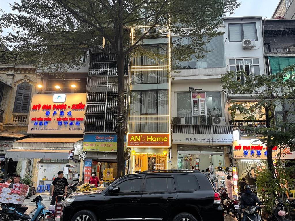 a black truck parked in front of a building at An's Home in Hanoi
