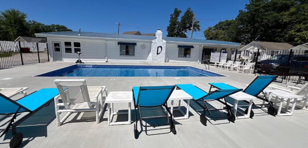 a group of chairs and a table and a pool at Dockside Lake Resort in Monticello
