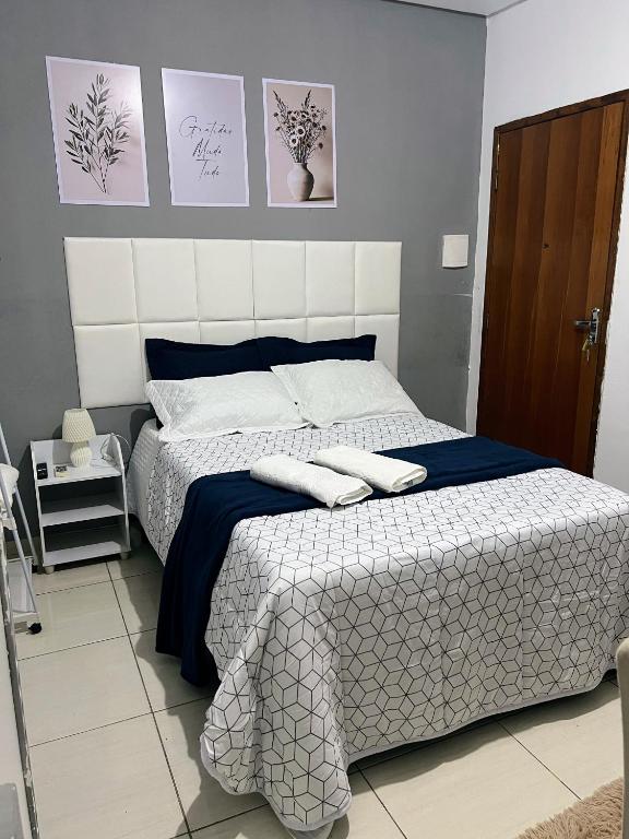 a bedroom with a bed with two towels on it at Royalties Flats in Petrolina