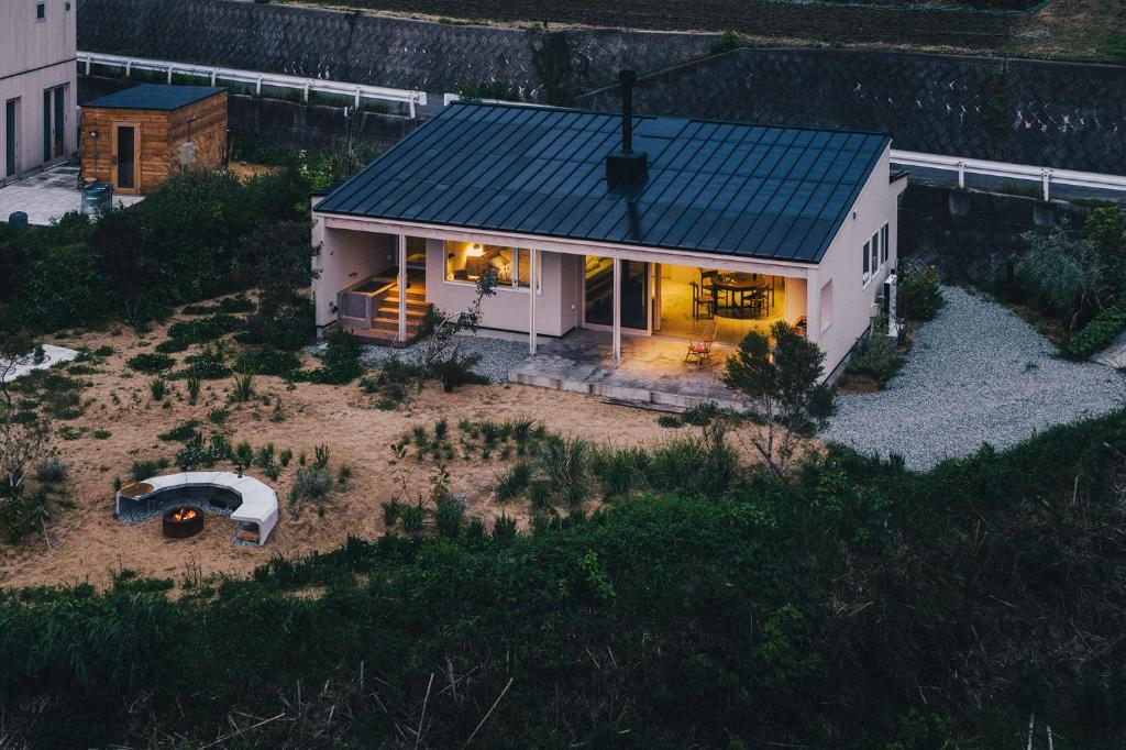 a small white house with a green roof at SANU 2nd Home CURRENT Awajishima in Awaji