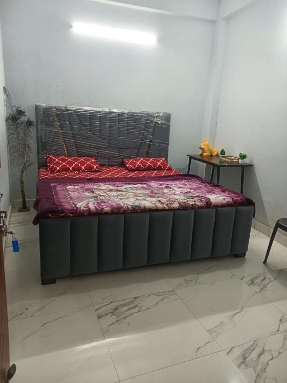 a bed in a room with a black bed frame at Independent homestay DDN in Dehradun