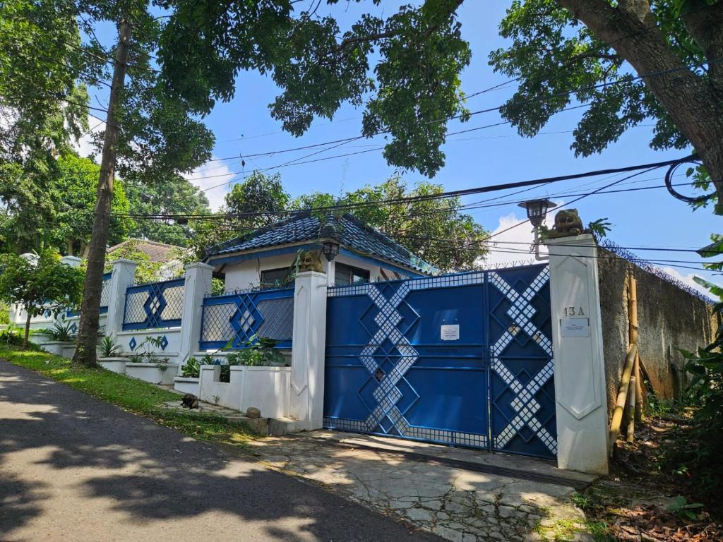 a blue gate in front of a house at Kuca Cigadung in Bandung