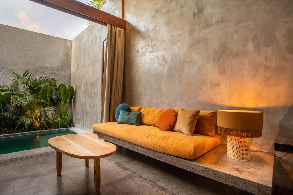 a living room with a couch and a table at The Echo Studios HUGE 100m to beach 1 in Badung