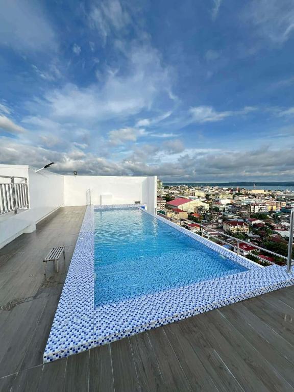 a swimming pool on the roof of a building at Bernwood Tower IloIlo - Heavens Crib in Iloilo City