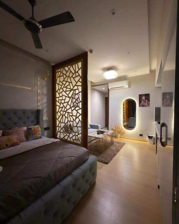 a bedroom with a bed and a living room at Galaxy Blue sapphire Plaza Square Residency in Ghaziabad