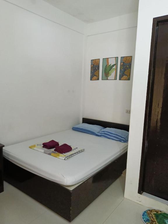 a small room with a bed in a room at Chelle's apartelle-inn in El Nido