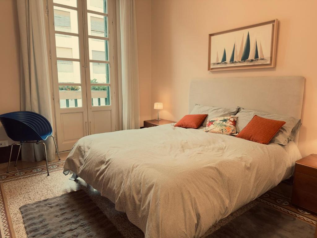 a bedroom with a bed with orange pillows and a window at L'Angolo di Palermo in Palermo