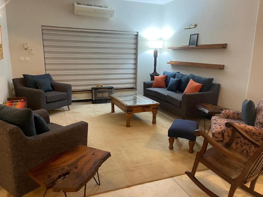 a living room with couches and a coffee table at New Apartment in Islamabad