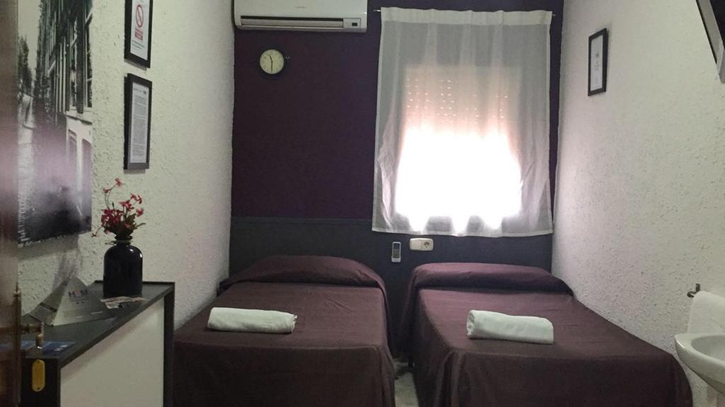 Postel nebo postele na pokoji v ubytování Hostal Restaurante Avenida de Madrid