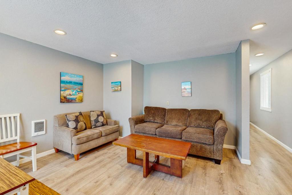 a living room with a couch and a table at Sea Treasures Inn #114 in Rockaway Beach