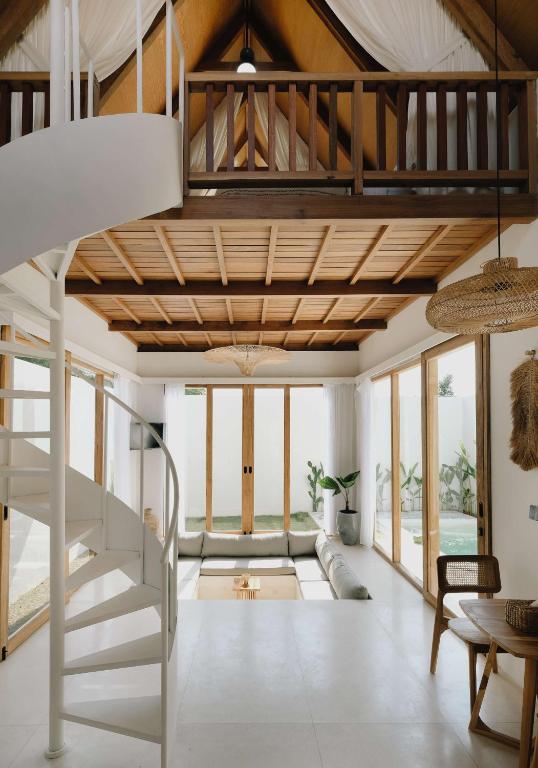 a living room with a loft bed and a staircase at Palm Valley Loft in Kuta Lombok