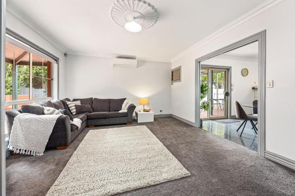 a living room with a couch and a table at The Laneway - 3BR, Pet Friendly, Walk to CBD in Port Lincoln