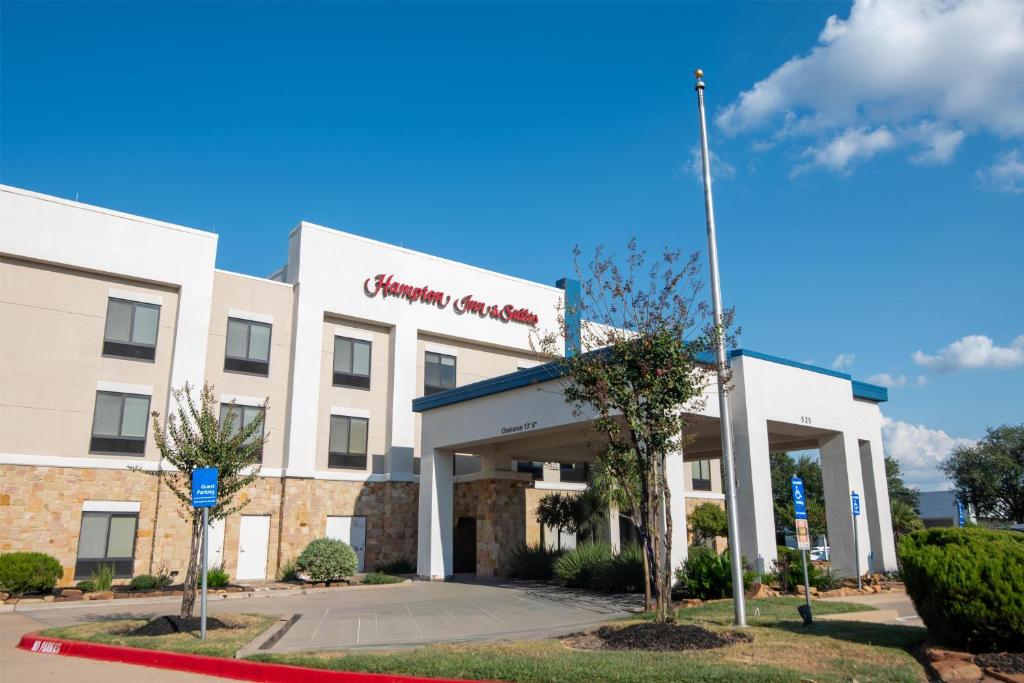 a front view of a holiday inn express hotel at Hampton Inn & Suites College Station in College Station
