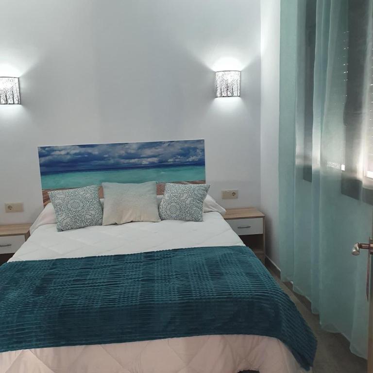a bedroom with a bed with a view of the ocean at B&B Ágora in Sayalonga