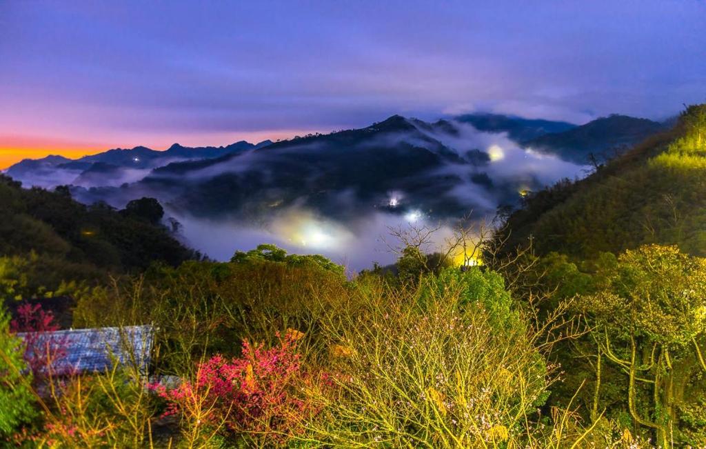 a view of a valley with clouds in the mountains at Natural Residence B&amp;B in Tai&#39;an