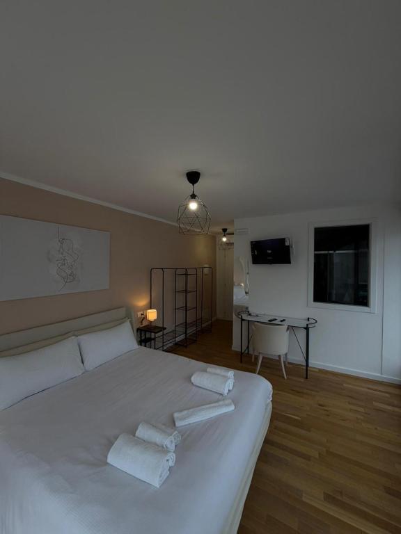 a bedroom with a white bed with towels on it at Rooms 78 in Castel di Sangro