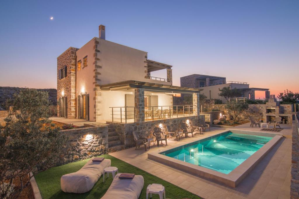 a villa with a swimming pool and a house at Charlise Luxury Villa by Cretevasion in Anópolis