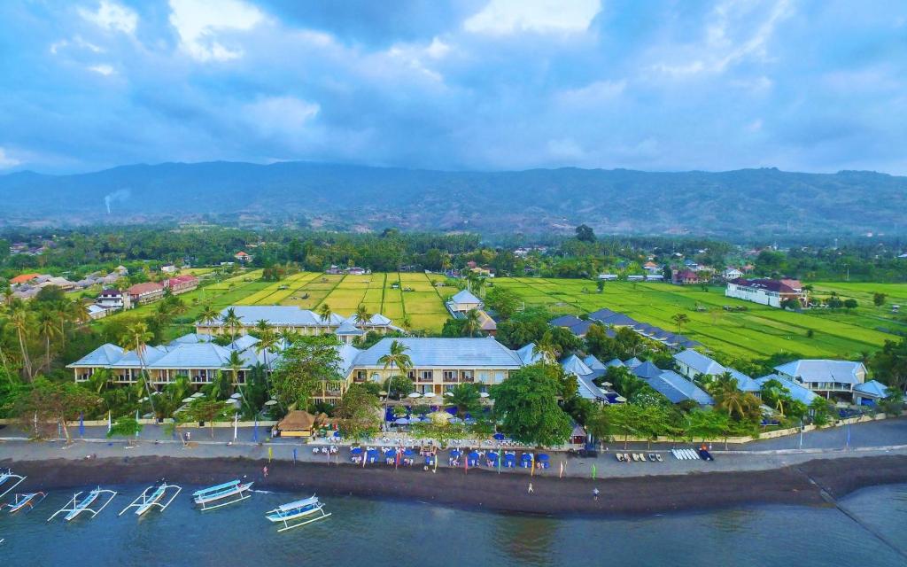 an aerial view of a resort with boats in the water at The Lovina in Lovina