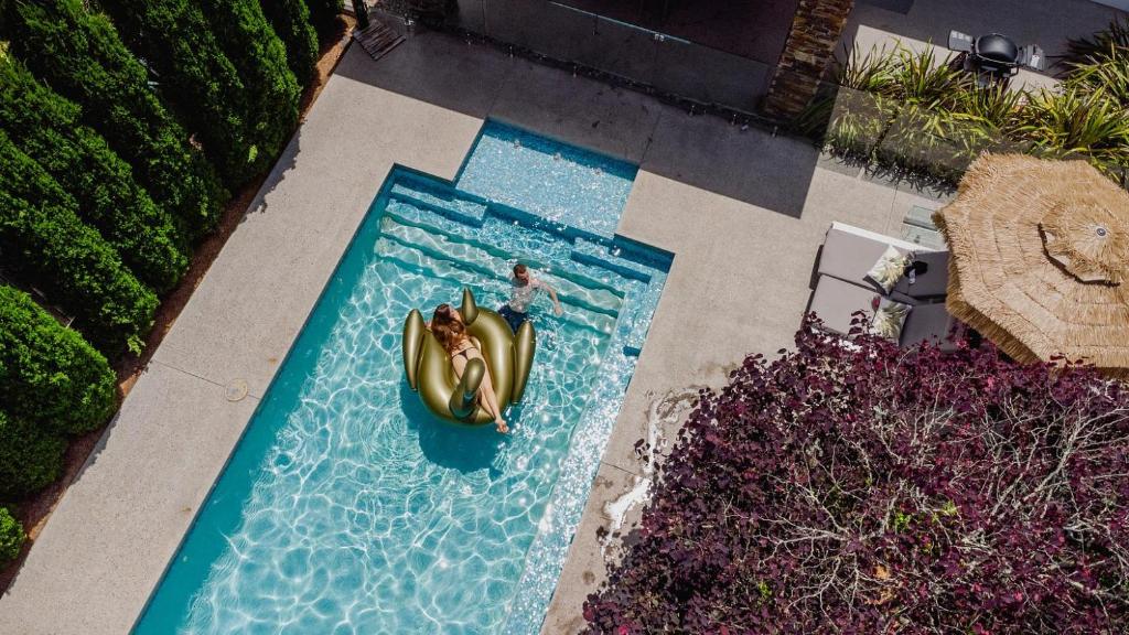 an overhead view of a person in a pool at Modern Luxuries Guesthouse in Berowra