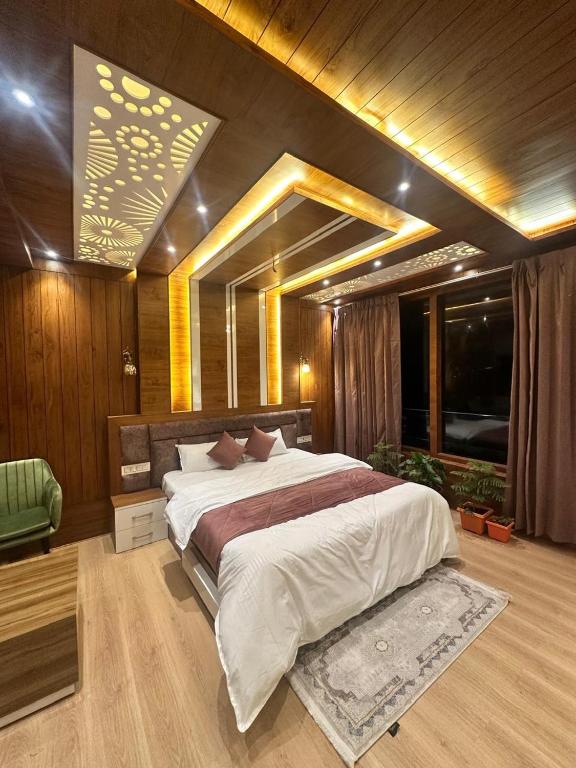 a large bedroom with a large bed and a window at Willow Winds Home Stay in Theog