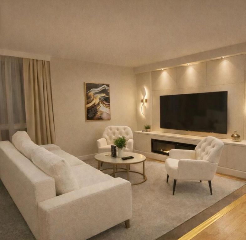 a living room with a couch and chairs and a television at Astral Court Premium Accomodation in Ruislip