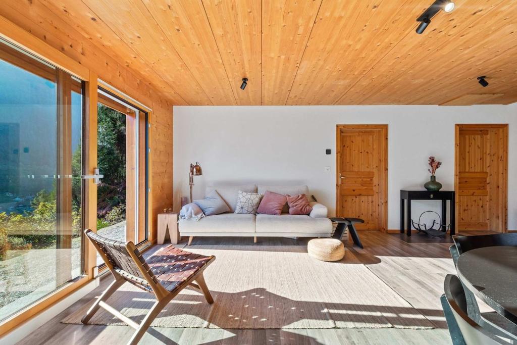 a living room with a couch and a table at Panoramic Alpine Garden Retreat in Vissoie