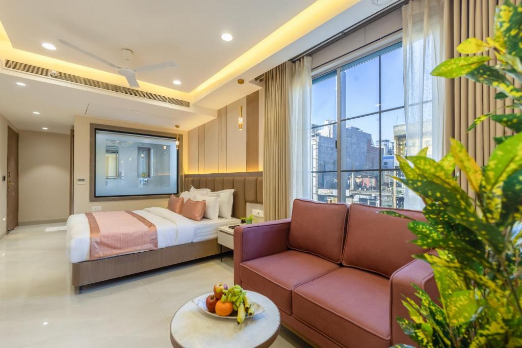 a hotel room with a bed and a couch at The Delhi Dreams - A Luxury Hotel in New Delhi
